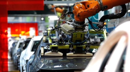 FILE PHOTO: A robot engineered by Kuka adjusts a windscreen in a fully automated process on a model of the A-class production line of German car manufacturer Mercedes Benz at the Daimler factory in Rastatt