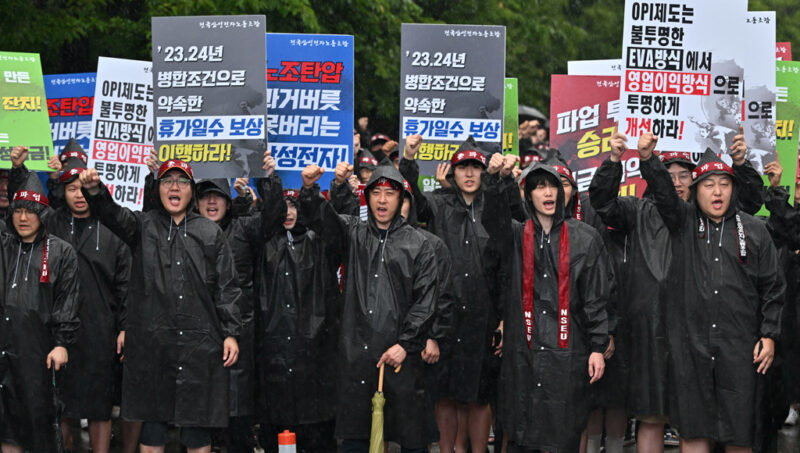 Members of the National Samsung Electronics Union stage a rally as they begin a three-day general strike outside the company's foundry and semiconductor factory in Hwaseong on July 8, 2024. Workers at South Korean tech giant Samsung began a three-day general strike over pay and benefits on July 8, the head of a union representing tens of thousands of employees told AFP, warning the action could impact key memory chip production. (Photo by Jung Yeon-je / AFP)