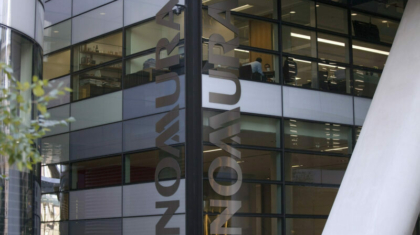 The Nomura company logo is seen on display at the U.K. headquarters of Nomura Asset Management Ltd, part of the Nomura Holdings Inc group in London, U.K., on Thursday, Sept.6, 2012. Nomura Holdings Inc. aims to derive almost half of its $1 billion in planned savings from Europe, where it will cut jobs for managing directors and back-office staff, two people with direct knowledge of the matter said. Photographer: Simon Dawson/Bloomberg