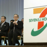 Noritoshi Murata, president and chief operating officer of Seven & I Holdings Co., left to right, Toshifumi Suzuki, chairman and chief executive officer, Masatoshi Ito, founder and honorary chairman, attend the company's initiation ceremony for new employees in Tokyo, Japan, on Thursday, March 13, 2014. Japanese labor unions said they clinched their biggest raises in years as Prime Minister Shinzo Abe calls for companies to boost wages to help put the worlds third-largest economy on a path to sustainable growth. Photographer: Akio Kon/Bloomberg via Getty Images