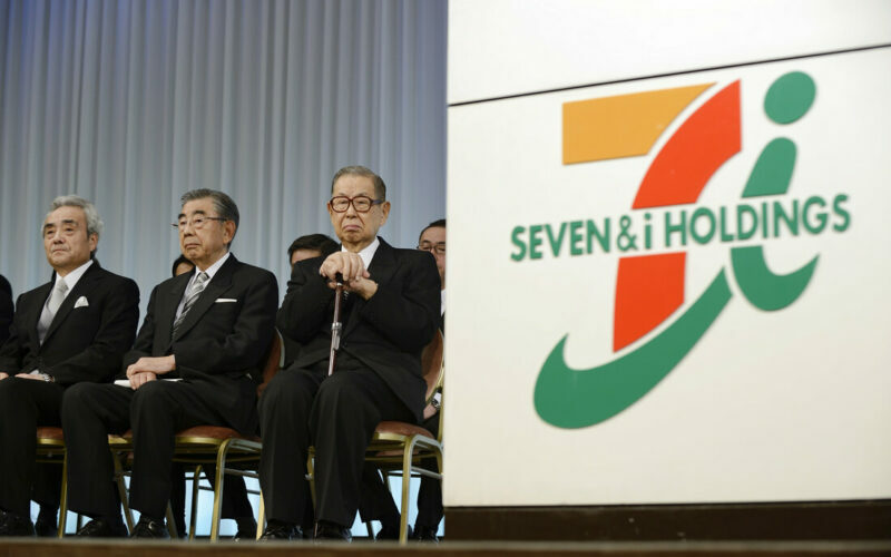 Noritoshi Murata, president and chief operating officer of Seven & I Holdings Co., left to right, Toshifumi Suzuki, chairman and chief executive officer, Masatoshi Ito, founder and honorary chairman, attend the company's initiation ceremony for new employees in Tokyo, Japan, on Thursday, March 13, 2014. Japanese labor unions said they clinched their biggest raises in years as Prime Minister Shinzo Abe calls for companies to boost wages to help put the worlds third-largest economy on a path to sustainable growth. Photographer: Akio Kon/Bloomberg via Getty Images